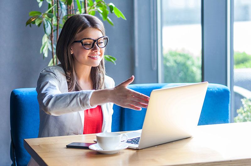 College student in professional outfit on laptop