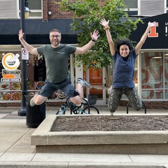 Two young adults jumping