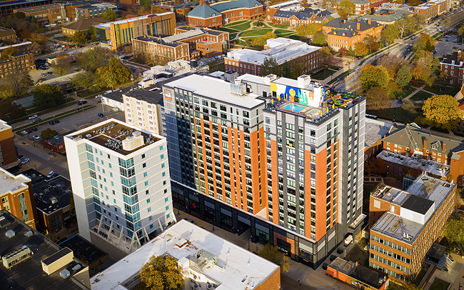 An apartment building with several stories from an aerial view