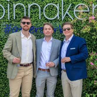 Group photo in front of an ivy wall