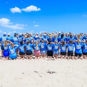 Team photo at a beach